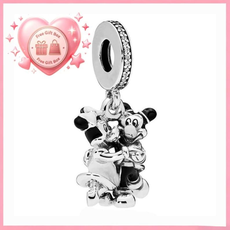 May include: A silver charm featuring Mickey and Minnie Mouse embracing. The charm has a circular top with a ring of small, clear stones. The figures are detailed with black and white accents.