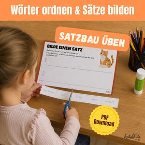 May include: A printable educational worksheet titled Bilde einen Satz featuring a cartoon cat illustration. The page includes instructions to cut out words and arrange them into a sentence. A strip of paper with the words Die Katze auf Sofa dem schlaft is being cut with scissors. A pencil holder and glue stick are nearby.