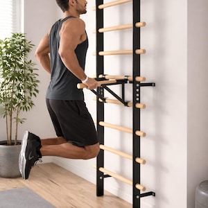 May include: A black and natural wood wall-mounted stall bar with a pull-up bar attachment. The stall bar has multiple wooden rungs and is mounted on a white wall. The pull-up bar is being used for exercise.