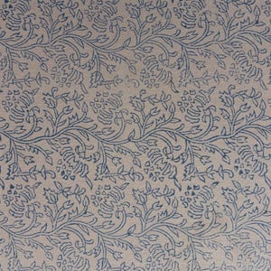 May include: A repeating pattern of blue floral vines and leaves on a cream-colored background. The design is evenly spaced across the fabric, creating a symmetrical and visually appealing textile.