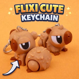 May include: Tan-colored keychain featuring a cartoon capybara design with a stern expression. The keychain has a silver ring and the text "FLIXI CUTE KEYCHAIN" in a blue and yellow font. The capybara has a brown nose and ears.