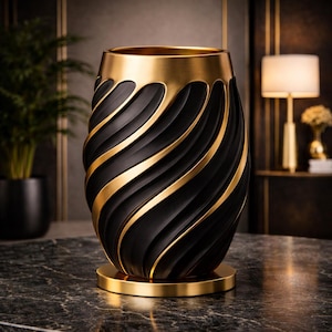 May include: An elegant black and gold vase with a swirling design. The vase has a black, textured body with gold accents and a gold rim and base. The decorative vase is a stylish home decor item.