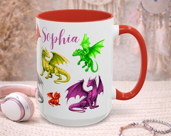 May include: White ceramic mug with a red interior and handle, featuring colorful dragon illustrations. The mug has the name "Sophia" in a cursive font. Dragons are in shades of green, yellow, red, and purple.