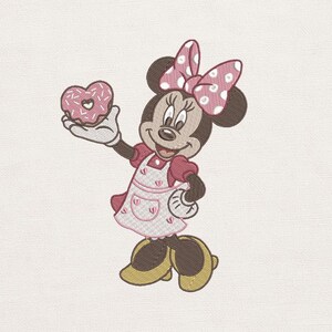 May include: An embroidered image of Minnie Mouse holding a pink heart-shaped donut. Minnie Mouse is wearing a pink dress, a white apron with pink trim, a polka-dot bow, and yellow shoes. The background is a plain off-white color.
