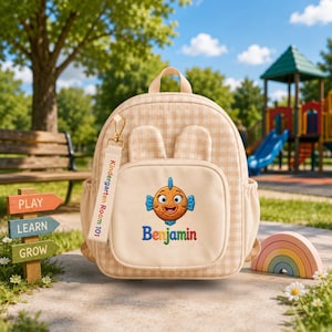 May include: A beige gingham backpack with two small ears on top, featuring an embroidered orange fish and the name Benjamin on the front pocket. A fabric tag attached to the zipper reads Kindergarten Room 101 in colorful letters.