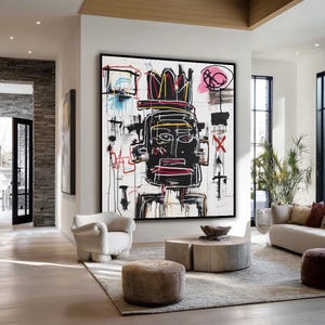 May include: Large framed abstract artwork. The painting depicts a black figure with a crown, highlighted by red, yellow, and pink details, set against a white backdrop. The artwork is displayed in a contemporary living room.