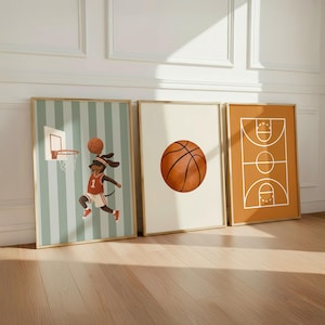 Puede incluir: Tres l&aacute;minas de pared enmarcadas con tem&aacute;tica de baloncesto. La primera muestra a un perro salchicha con camiseta roja y blanca saltando hacia una canasta. La segunda muestra un bal&oacute;n centrado sobre fondo crema. La tercera muestra un diagrama.