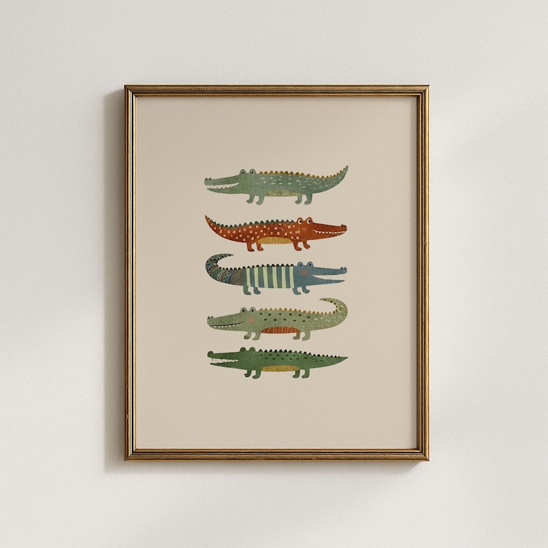 Puede incluir: Una l&aacute;mina de arte enmarcada que muestra cinco cocodrilos apilados en fila. Los cocodrilos est&aacute;n ilustrados en varios colores, incluyendo verde, naranja y azul, con patrones de rayas y puntos sobre un fondo de color beige claro s&oacute;lido.