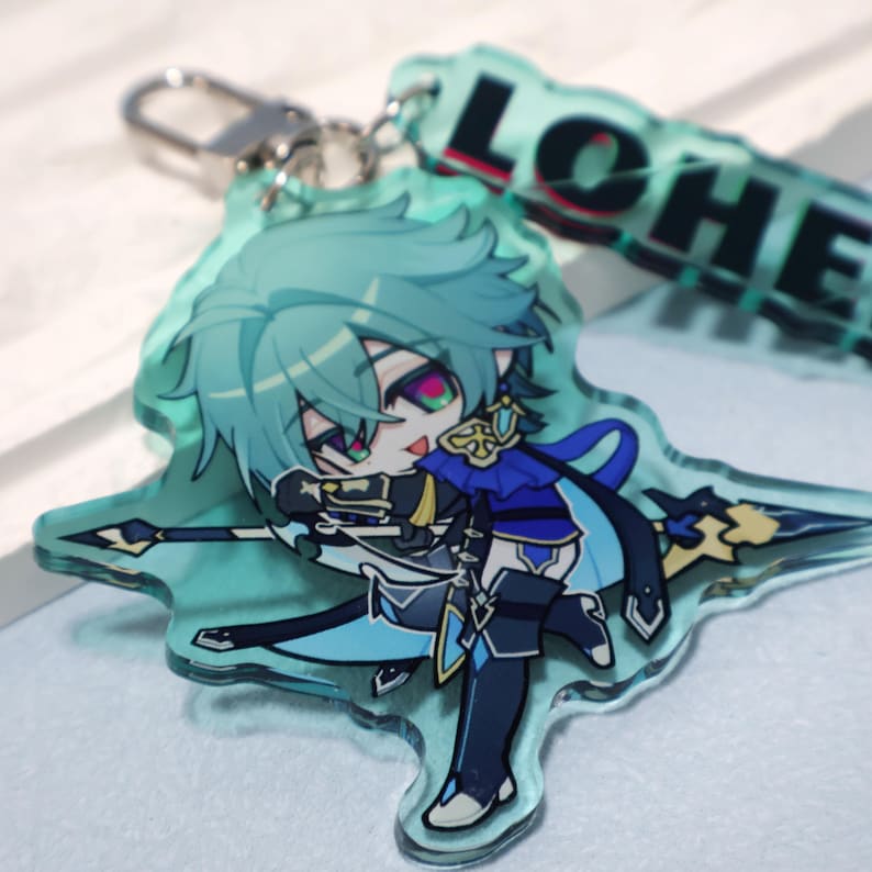 May include: A translucent light green acrylic keychain featuring a chibi-style character with teal hair, wearing a blue and black outfit, and holding a spear. The keychain includes a silver metal clasp and a separate tag with the text LOHE.