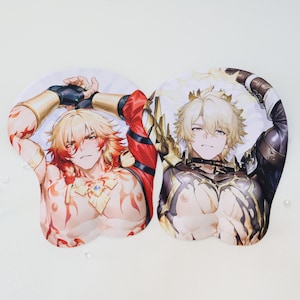 May include: Two ergonomic mouse pads featuring anime-style illustrations of male characters. One pad has a character in red and gold attire, the other in black and gold armor. Both have a wrist rest and are on a white background.
