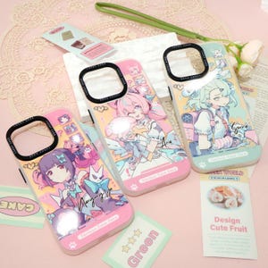 May include: Three phone cases with anime-style character designs. The cases are pink, light green, and pink, each featuring a different character illustration. The cases have black camera rings and the text "Lucky Case" is visible. The cases are on a pink surface.
