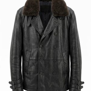 May include: A black leather jacket featuring a double-breasted button front, a dark brown faux fur collar, and adjustable buckle straps at the cuffs. The jacket includes two side pockets and a structured lapel design with additional buckle detailing.