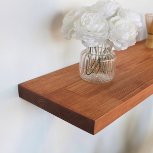 May include: A trio of ceramic mugs with a speckled, matte finish in cream, light grey, and dark grey. Each mug features a minimalist design and a rounded handle.