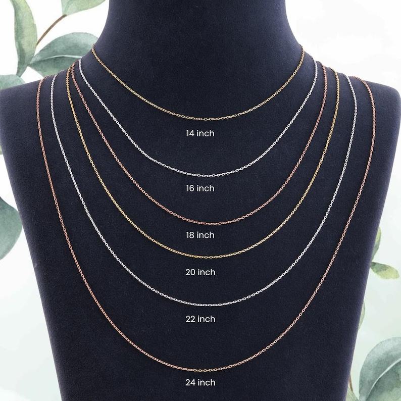 May include: Six delicate chain necklaces of varying lengths, from 35.5 cm to 61 cm, are displayed. The chains are in gold, silver, and rose gold tones. Each chain is labelled with its length in inches, with the equivalent in cm.