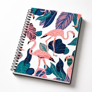 May include: A spiral-bound notebook featuring a white cover with a repeating pattern of pink flamingos and large tropical leaves in shades of dark blue, teal, and light pink. The notebook has a black metal wire coil along the left side edge.
