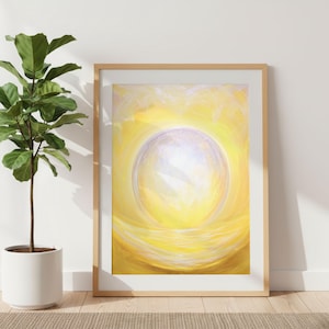 May include: A framed abstract art print featuring a bright yellow and white color palette. The artwork depicts a central sphere of light surrounded by swirling brushstrokes. The frame is a light wood color, and a potted plant is visible in the corner.
