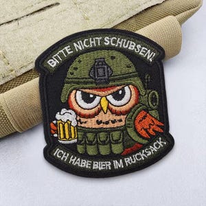 May include: A set of three ceramic mugs with a speckled, cream-colored glaze. Each mug features a different hand-painted floral design in shades of blue, green, and yellow. The mugs have a simple, rounded shape and a comfortable handle.