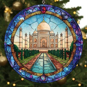 May include: Round stained glass ornament featuring the Taj Mahal. The design includes a central image of the white marble mausoleum, surrounded by a blue and purple stained glass border. The ornament is hanging from a silver hook.