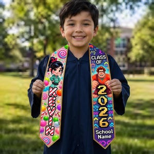 May include: A graduation stole with a colorful design featuring cartoon characters and the text "KEVIN" and "CLASS OF 2026". The stole has a gold border and is decorated with candy and pixelated graphics. The school name is also displayed.