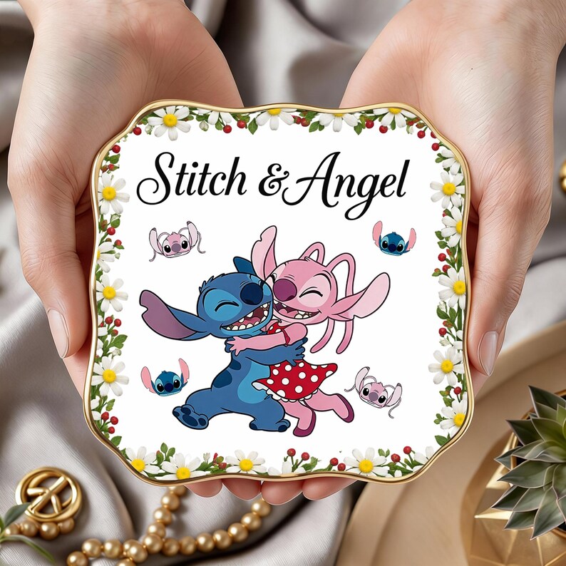 May include: A white ceramic mug with a black handle and the text "But First, Coffee" in a bold, black font. The mug is set against a blurred background, suggesting a cozy setting.