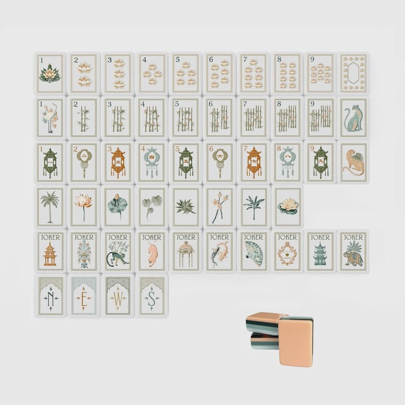 May include: A set of rectangular mahjong tiles featuring various illustrations including numbers one through nine, botanical motifs, animals, lanterns, and joker tiles. Four tiles at the bottom display the letters N, E, W, and S. A small stack of tiles sits separately.