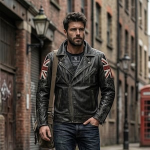 May include: A black leather motorcycle jacket featuring a wide collar, quilted shoulder and sleeve detailing, and a Union Jack flag patch on each upper arm. The jacket includes a front zipper closure, zippered pockets, and a dark inner shirt.