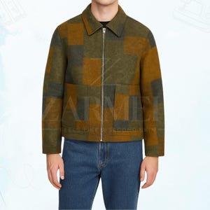 May include: A green, brown, and grey checked jacket with a zip fastening and two front pockets. The jacket has a collared neckline and is worn with blue jeans. The text "ZARMEI FEELS LIKE SECOND SKIN" is visible.