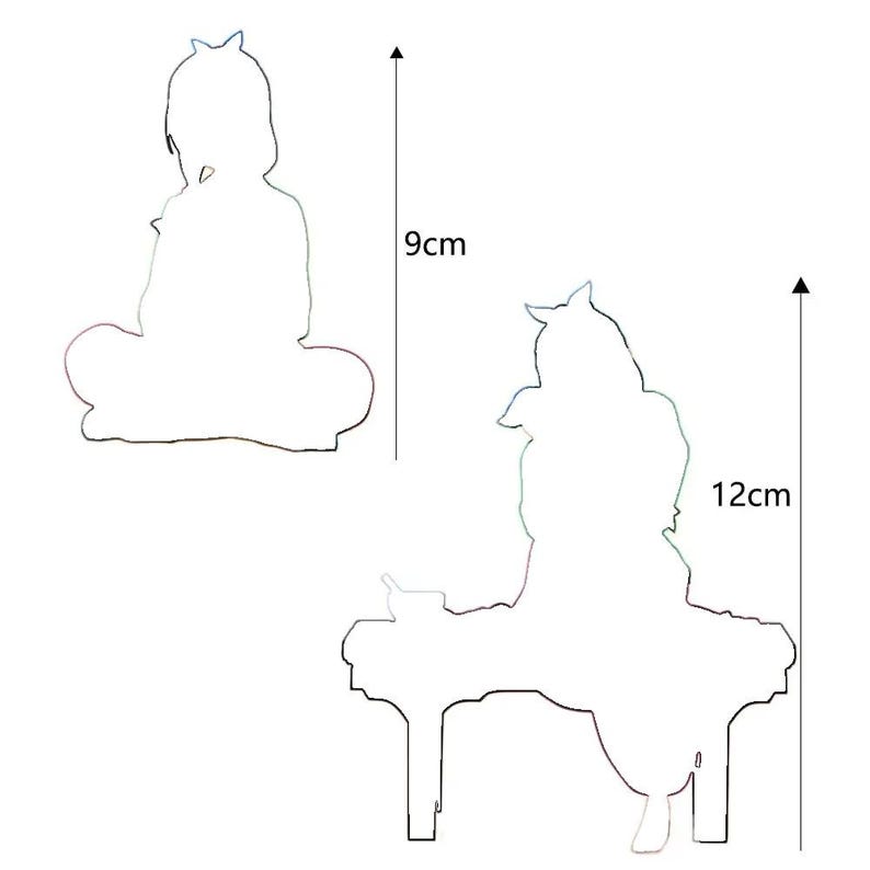 May include: Two white silhouette cutouts of a seated figure, one 9 cm tall and the other 12 cm tall. The figures have a crown-like detail on their heads. The larger figure is seated at a table.
