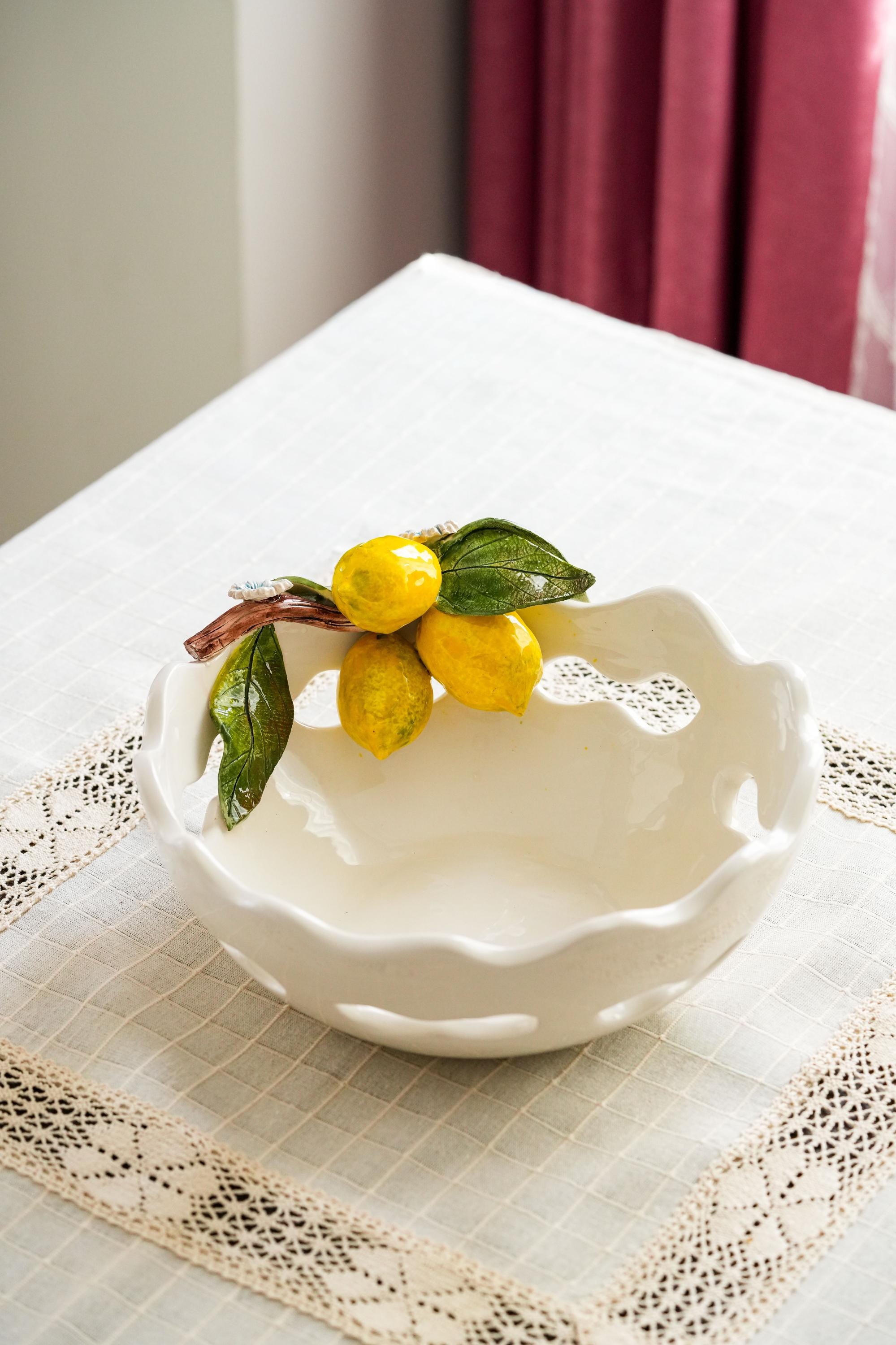 modern minimalist single statement centerpiece on kitchen table, oversized ceramic bowl with lemons