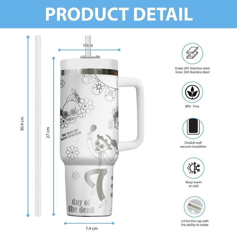 May include: White stainless steel travel mug with a handle, straw, and lid. The mug features Day of the Dead themed graphics and text. It measures 30.4 cm tall, 27 cm in height, and 7.4 cm wide.