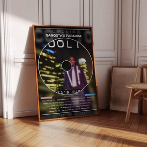 May include: A framed poster featuring the album cover for Coolio's "Gangsta's Paradise." The image shows a circular design with a portrait of Coolio, set against a cityscape. The poster includes the album title, tracklist, and the date November 7, 1995.