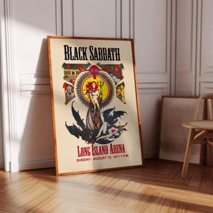 May include: A framed vintage Black Sabbath concert poster for Long Island Arena. The poster features a central illustration of a woman with red hair and a trident, surrounded by gothic imagery and the band's name.