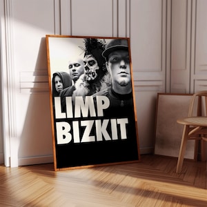 May include: A framed poster featuring the band Limp Bizkit. The poster has a black background with the band's name in large white letters. The band members are in the foreground, with a skull-faced figure prominent.