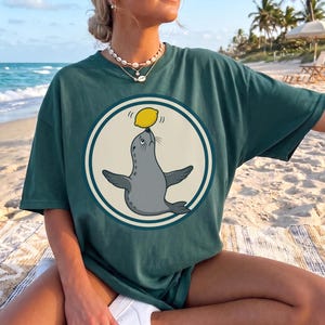 Lemon Balancing Seal Shirt, Funny Circus Animal Art Tee, Citrus Seal Humor Gift, Quirky Offbeat Animal, Seal Graphic Tee Gift Him Her