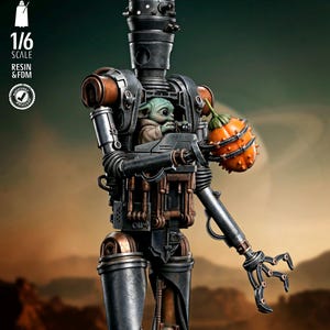 May include: A detailed 1/6 scale resin and FDM model of a droid with a baby alien inside. The droid is primarily dark gray with copper-colored accents. The baby alien is green and holding a spiky orange fruit. The model is set against a blurred desert background.