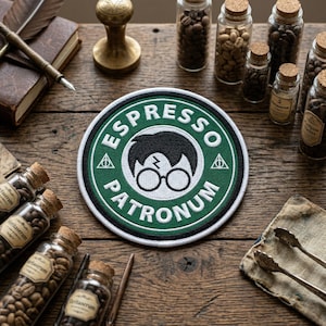 May include: A white ceramic mug with a black handle and the text "But First, Coffee" in a handwritten style. The mug is on a white surface. The mug is 4 inches tall.