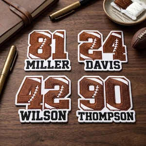 May include: Four embroidered football patches with numbers and names: "81 MILLER", "24 DAVIS", "42 WILSON", and "90 THOMPSON". The patches are brown and white, resembling footballs. A football, pens, and a notebook are also visible.