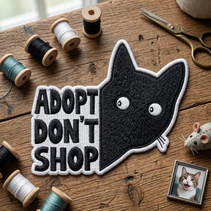 May include: A set of three ceramic mugs with a speckled, cream-colored glaze. Each mug features a different hand-painted design: a blue and green leaf, a yellow flower, and a red berry. The mugs have a simple, modern design.