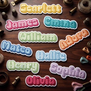 May include: A collection of embroidered name patches in various colors including yellow, pink, teal, green, blue, orange, purple, and red. Each patch features a puffy, rounded font with a white border, displaying names like Scarlett, James, Emma, William, Adora, Mateo, Hallie, Henry, Sophia, and Olivia.