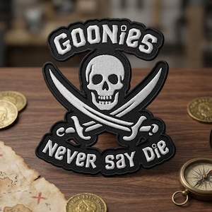 May include: A white ceramic mug with a black handle and the text "But First, Coffee" in a bold, black font. The mug is set against a blurred background, suggesting a cozy setting.