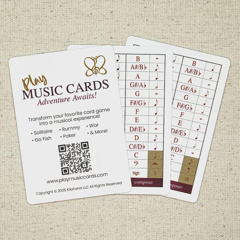 May include: Three white music cards with musical notes and text. The cards have the text "Play Music Cards Adventure Awaits!" and a QR code. The cards transform card games into a musical experience.