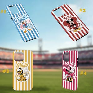 May include: Four phone cases with cartoon character designs. The cases feature Donald Duck, Mickey Mouse, Pluto, and Minnie Mouse. Each case has a different color scheme and striped pattern. The background is a blurred image of a stadium.