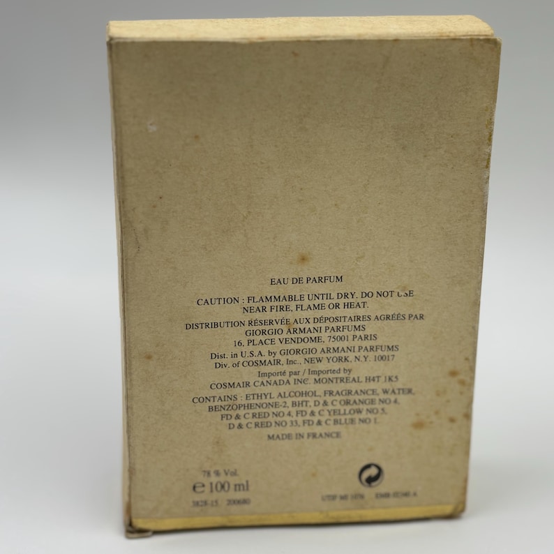 May include: A vintage perfume box with text in English and French. The box is beige with dark brown text, including warnings and ingredient information. The box contains 100 ml of perfume.