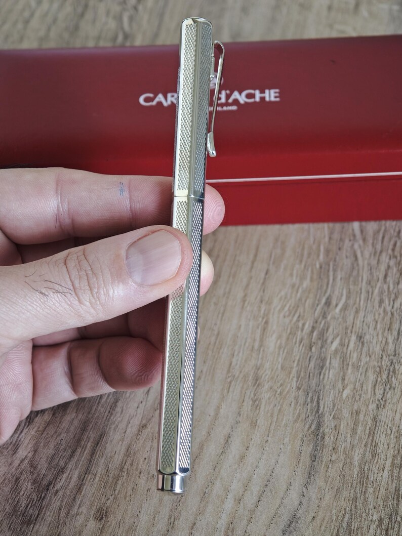 May include: A set of three ceramic mugs with a speckled, matte finish. The mugs are in shades of cream, light gray, and dark gray. Each mug has a simple, minimalist design and a rounded handle. The mugs are likely for coffee or tea.