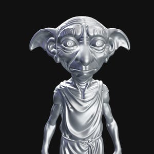 May include: A silver-colored statue of a house elf with large ears, a long nose, and a draped tunic. The figure has a detailed, textured appearance and is set against a black background. The statue is a representation of a character from a fantasy series.