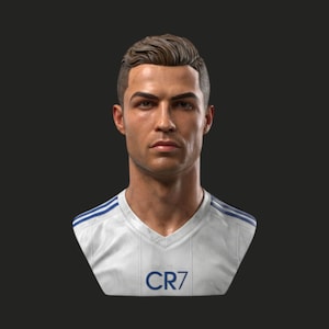 Puede incluir: Busto de un hombre con cabello castaño corto y peinado, con una expresión seria. Viste una camiseta blanca con cuello en V y rayas azules en los hombros, con las letras "CR7" impresas en el frente. Fondo gris oscuro.