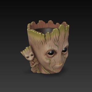 May include: A brown and green Groot-themed planter. The planter features a detailed design of Groot's face with a smaller Groot figure on the side. The planter has a dark interior and is made of a durable material.