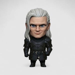 May include: A figurine of a character with pale skin, long white hair, and blue eyes. The figure is dressed in black armour with a quilted pattern and a belt with a silver buckle. The figurine is standing on a white surface.
