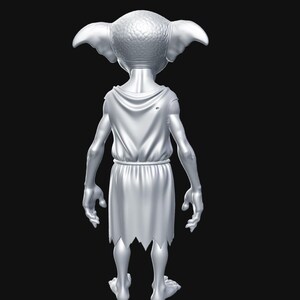 May include: A silver figurine of a creature with large ears, wearing a draped tunic with a torn hem. The figure is posed with its back to the viewer, set against a black background. The figurine has a detailed texture.