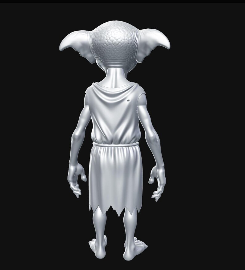 May include: A silver figurine of a creature with large ears, wearing a draped tunic with a torn hem. The figure is posed with its back to the viewer, set against a black background. The figurine has a detailed texture.